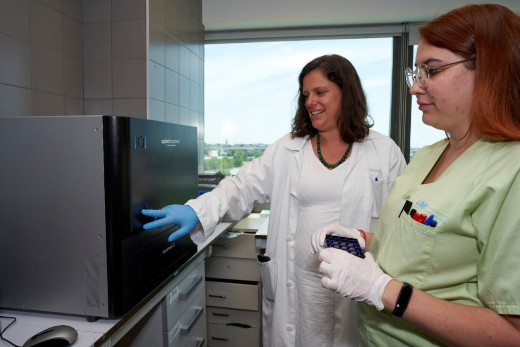Two scientists looking at Applied Biosystems QuantStudio Absolute Q Digital PCR System.