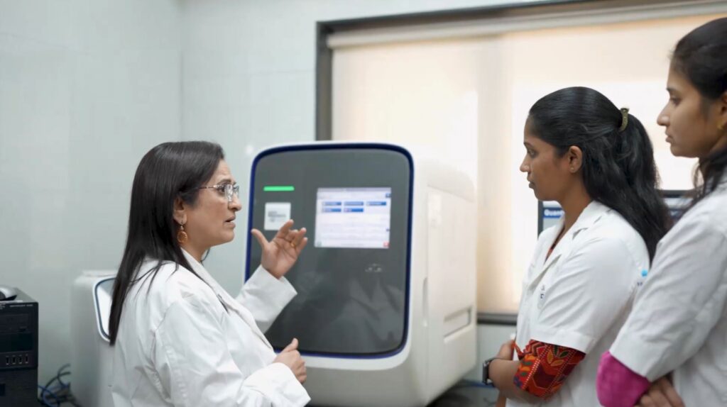 Dr. Chougule speaks with her team