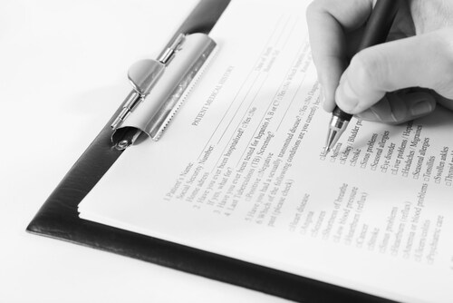 Filling out a medical form. Image: Africa Studio/Shutterstock.com