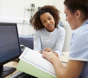 Doctor discussing test results with a young adult. Image: Monkey Business Images/Shutterstock.com
