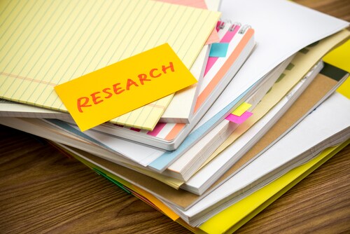 Research; the pile of business documents on the desk. Image: Eiko Tsuchiya/Shutterstock.com.