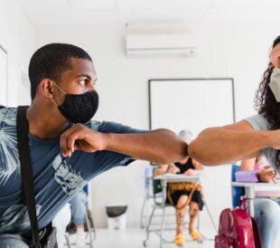 Masked students elbow greeting