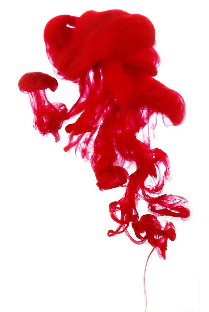 Red ink cloud in water isolated on a white background