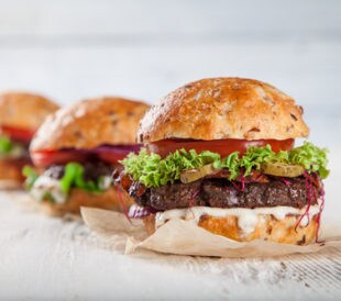 Close-up of three hamburgers. Image: Lukas Gojda/Shutterstock.com