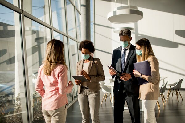 office works wearing masks to help protect against covid