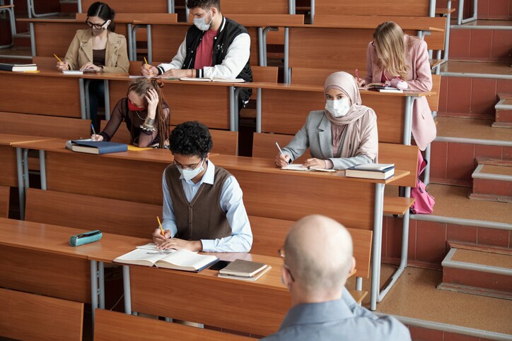 picture of college classroom with students wearing covid masks