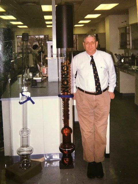 Moshe Hirshberg stands next to an oversized version of a ROSS Sure-Flow Electrode.