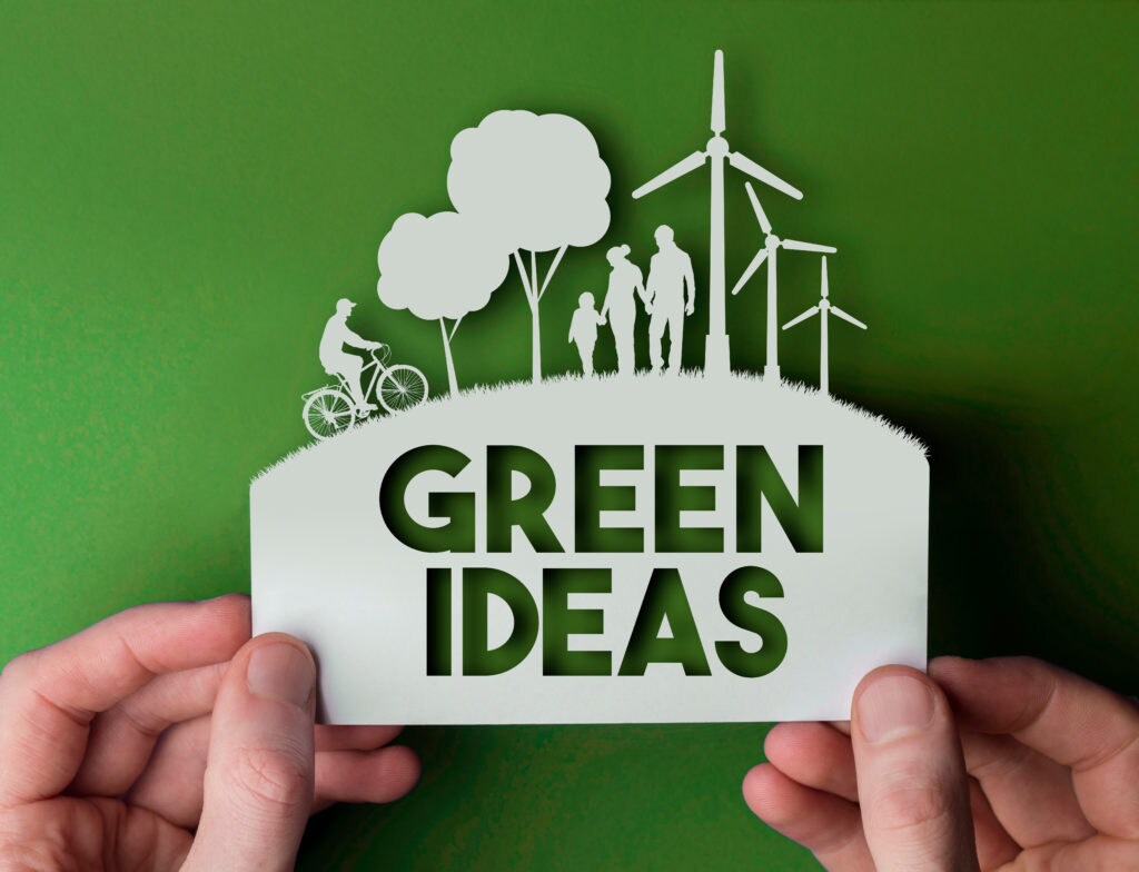 Green Ideas - green environmental paper background with wind turbines, trees and people