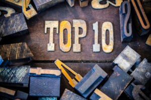 The words TOP 10 written in rusted metal letters surrounded by vintage wooden and metal letterpress type.