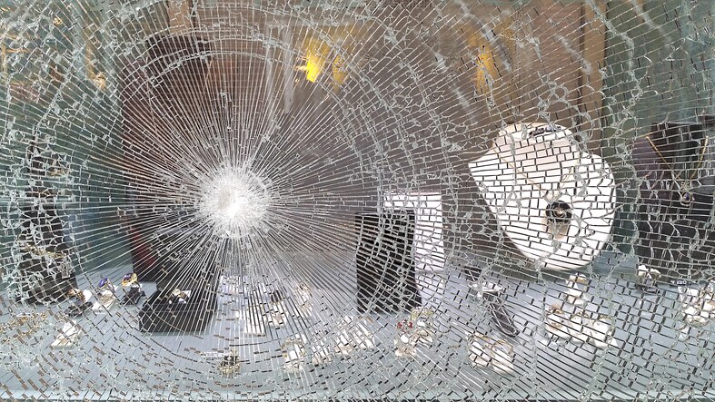 Broken window in jeweller's shop after raid