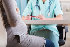 Close-up of a pregnant woman during medical visit. Image: Photographee.eu/Shutterstock.com.
