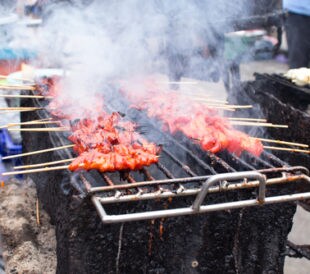 Smoky pork grill, meat cooked at high temperatures danger food and cancer risk from heterocyclic amines (HCAs) and polycyclic aromatic hydrocarbons (PAHs). Image: Microstock-Thailand/Shutterstock.com.