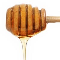 honey dripping from dipper